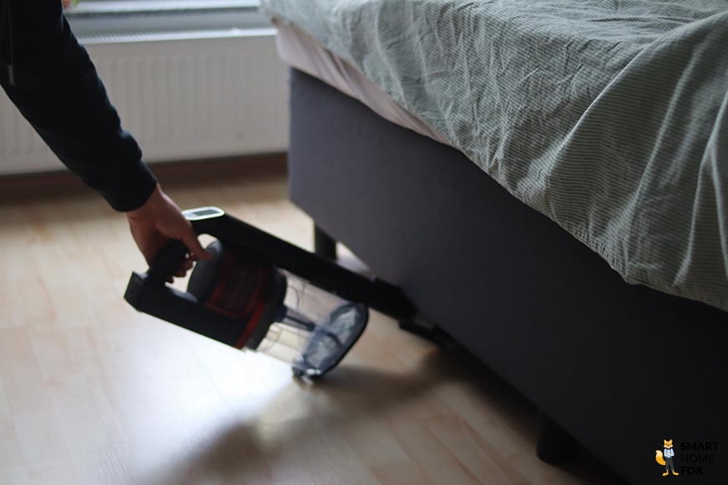 Shark Anti Hair Wrap Flexoloxy is seen cleaning under furniture.